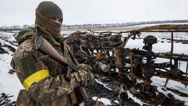 A Ukrainian serviceman of the 93rd Independent Kholodnyi Yar Mechanized Brigade examines a destroyed military vehicle. Picture: AFP