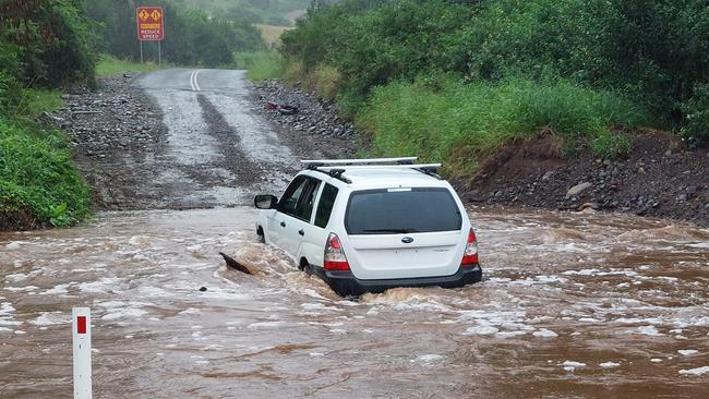 A vehicle drives through floodwaters at Upper Flagstone Creek Road, in the Lockyer Valley. Picture: Supplied