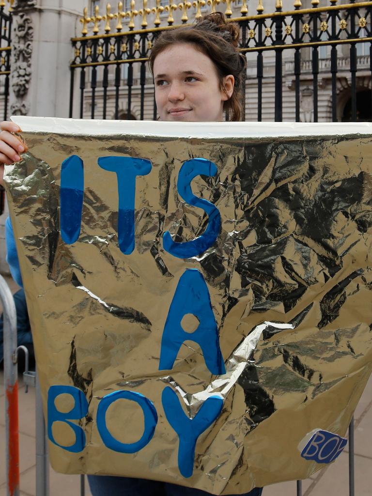 A royal fan celebrates the news outside of Buckingham Palace. Picture: AFP