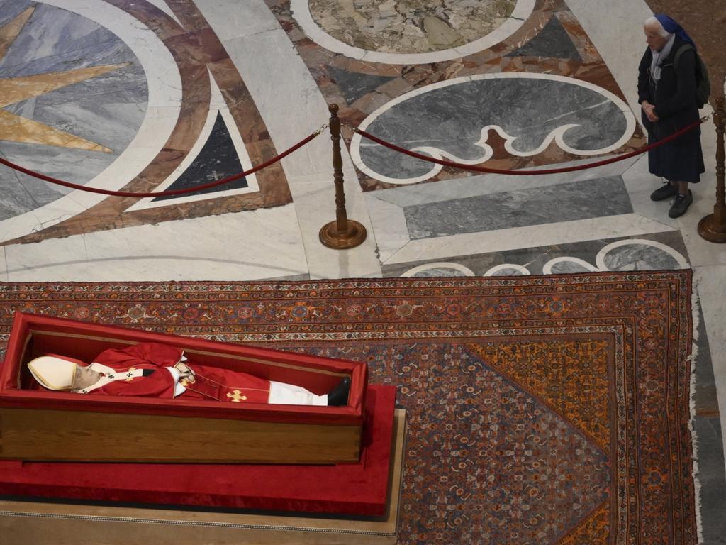 Sister Genevieve Jeanningros prays in front of the body of late Pope Francis inside St. Peter's Basilica at the Vatican. Picture: AP