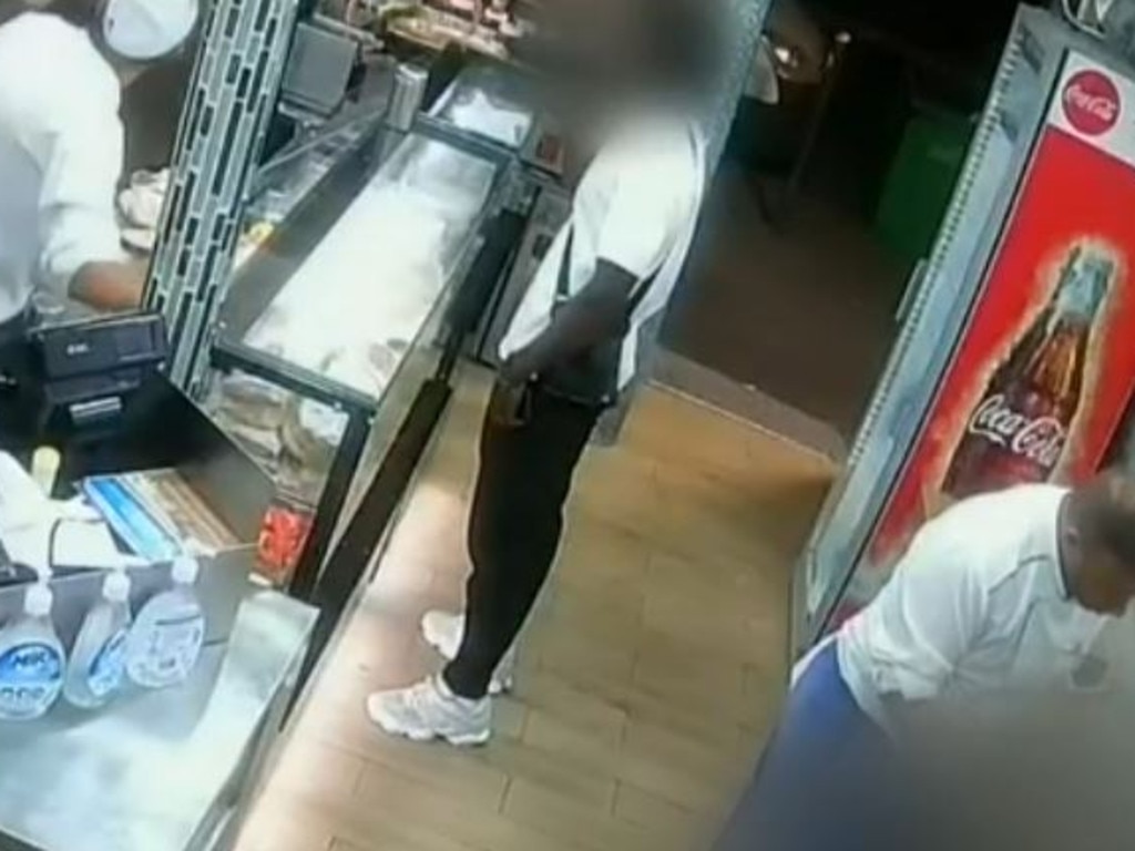 CCTV footage shows a man (centre, blurred) enter a Paris kebab shop, which the woman accuses of being her attacker.