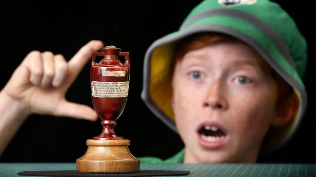 Cricket fan Fletcher 12, gets a close-up look at the urn. Picture: David Caird