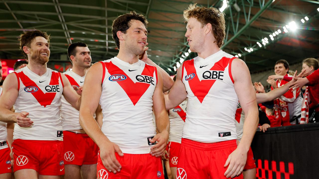 MELBOURNE, AUSTRALIA - AUG 16: Callum Mills and Oliver Florent of the Swans leave the field after a win during the 2024 AFL Round 23 match between Essendon Bombers and the Sydney Swans at Marvel Stadium on August 16, 2024 in Melbourne, Australia. (Photo by Dylan Burns/AFL Photos via Getty Images)