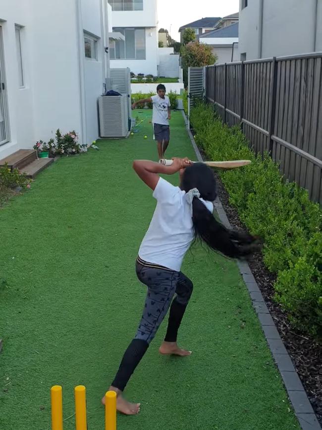 10-year-old Hills Barbarians player Kaya Kumar practising her batting in the backyard. Picture: Contributed