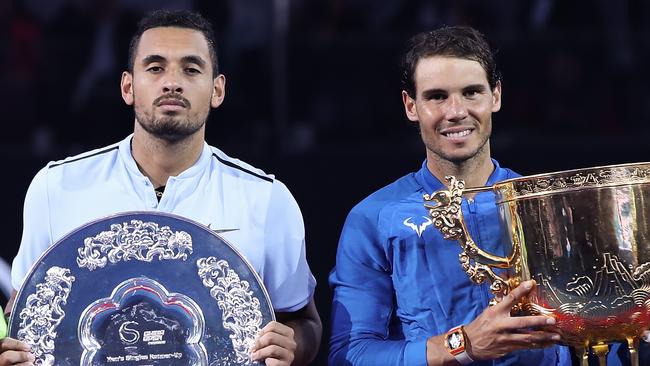 Rafael Nadal of Spain holding the winner's trophy with Nick Kyrgios.