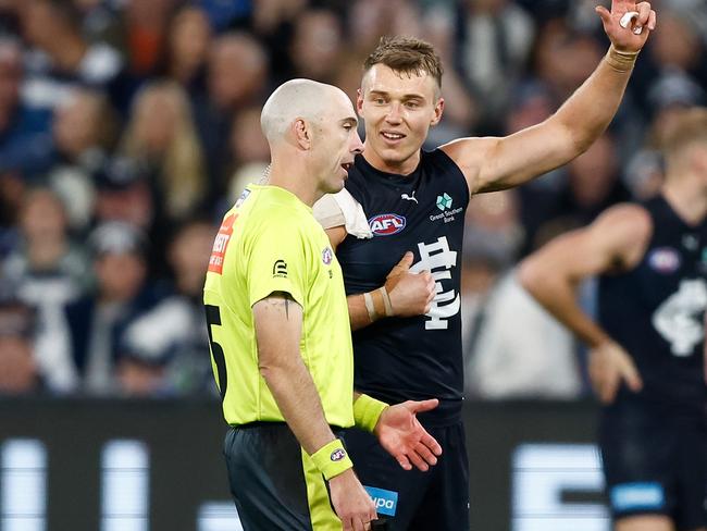 MELBOURNE, AUSTRALIA - APRIL 27: Patrick Cripps of the Blues and AFL Field Umpire, Mathew Nicholls share a discussion during the 2024 AFL Round 07 match between the Geelong Cats and the Carlton Blues at the Melbourne Cricket Ground on April 27, 2024 in Melbourne, Australia. (Photo by Michael Willson/AFL Photos via Getty Images)