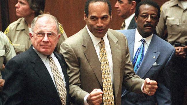 Murder defendant OJ Simpson (C) listens to the not guilty verdict with his attorneys F. Lee Bailey (L) and Johnnie Cochran Jr (R) in Los Angeles. Picture: AFP.