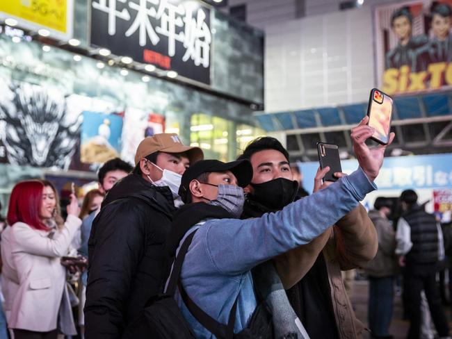 People take selfies in front of Shibuya station in Tokyo, Japan. Picture: Getty Images