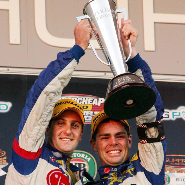 Jamie Whincup (L) and Craig Lowndes on podium with the Peter Brock trophy after winning 2006 Bathurst 1000.