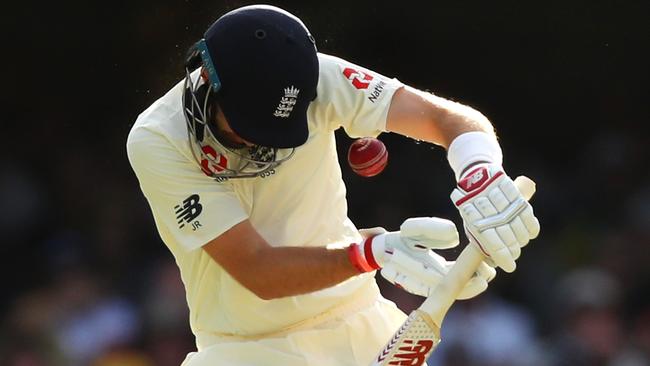 Joe Root is rocked by a Mitchell Starc bouncer.