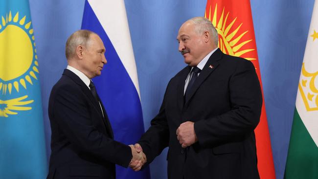 Putin greets Belarus' President Alexander Lukashenko during an informal summit on December 25. Picture: AFP