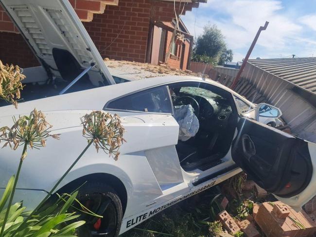 The luxury car moments after ploughing into the home.