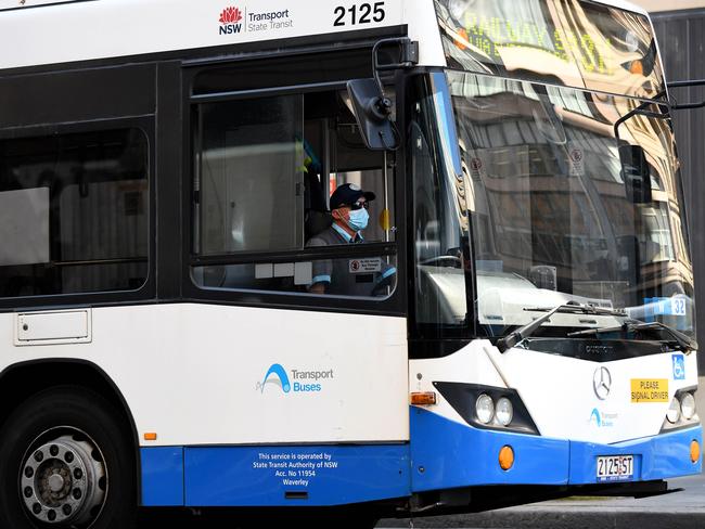 SYDNEY, AUSTRALIA - NCA NewsWire Photos AUGUST, 27, 2020: A bus driver is seen wearing a face ask, to help prevent the spread of COVID-19, onboard a State Transit Authority (SA) bus in the CBD of Sydney. Sydney contact tracers are working in overdrive after a trainee bus driver travelled on more than a dozen routes across the North-West while infectious with COVID-19. Picture: NCA NewsWire/Bianca De Marchi