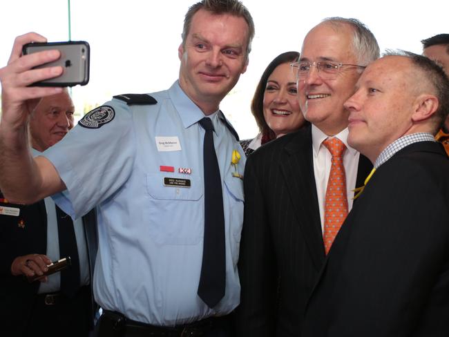 Prime Minister Malcolm Turnbull takes selfies at a round table discussion with Volunteer Fire Brigade Victoria and Country Fire Authority members at the Highton Bowls Club on June 23, 2016 in Geelong, Australia. The Coalition Government’s $20 million jobs and investment package is aimed at boosting local enterprise and employment pathways for local workers, as well as turning Avalon Airport into an international airport. (Photo by Stefan Postles/Getty Images)