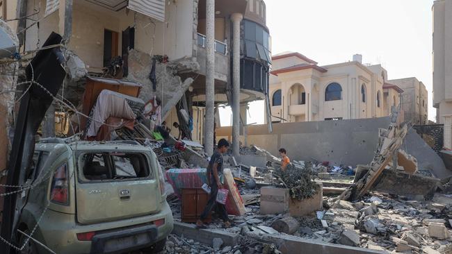 Palestinians inspect the damage following an overnight Israeli bombardment of a house at the Nuseirat refugee camp in the central Gaza Strip on Wednesday. Picture: AFP