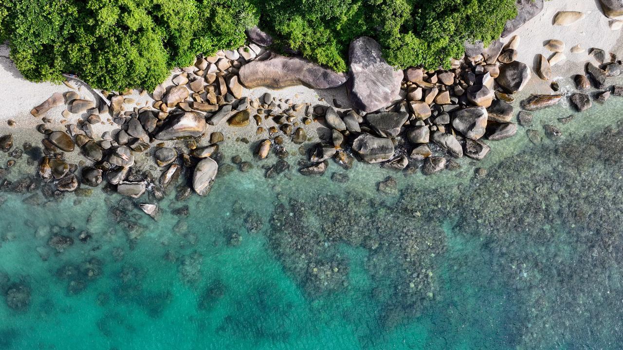 Aerial photo of coral and, fish and sea life growing on a fringing reef right off the shore of Fitzroy Island, located in the Great Barrier Reef Marine Park, off the coast of Cairns in Far North Queensland. Picture: Brendan Radke