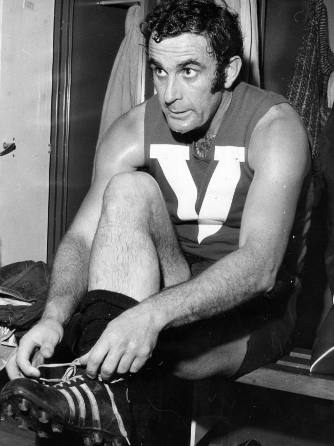 Hammond laces his boots prior to a match for North Adelaide in 1973...