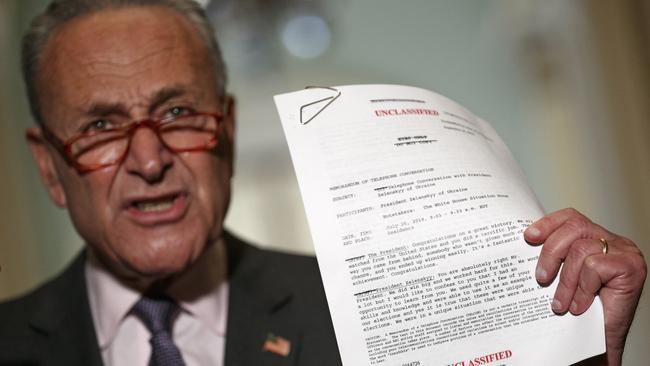 Senate Minority Leader Sen. Chuck Schumer holds up a copy of a released transcript of a phone call between President Donald Trump and the President of Ukraine.