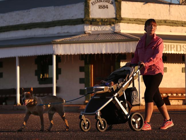 Sunrise very early morning is the only way to avoid the soaring temperatures , Elise Taylor, 25, with baby Maxamus and dog Turbo enjoy a walk outside the historic Birdsville Pub, as the sun rises on another scorching day in the outback Queensland town. bxb1 . Brirdsville QLD