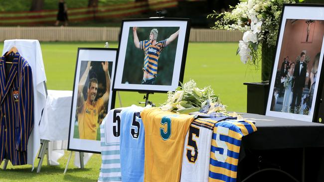 Photographs and jerseys at Dan Vickerman’s Memorial service on the No. 1 oval at Sydney University. Picture: Mark Evans
