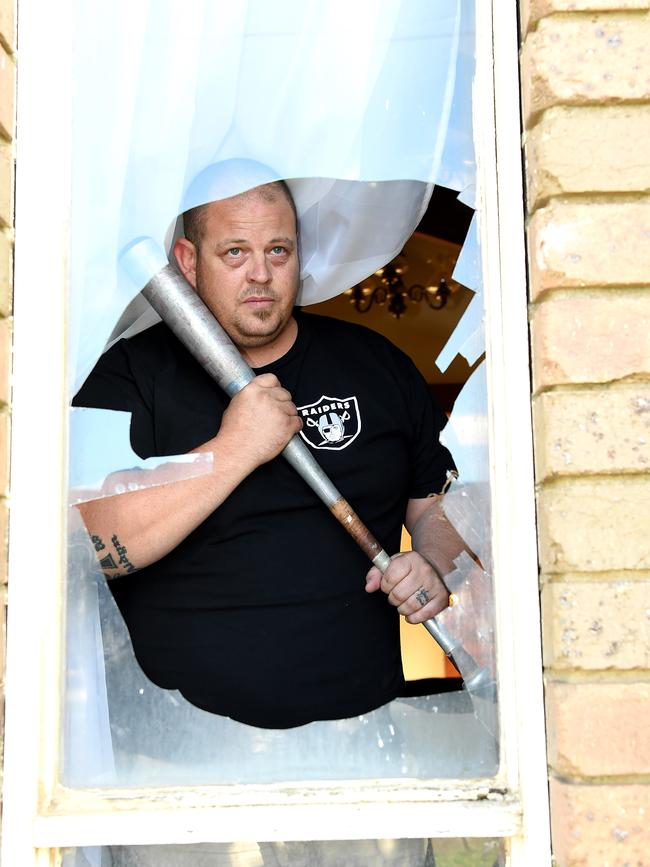 Jeremy Lynch armed himself with a baseball bat to protect his family after a huge rock was thrown through his window in Werribee. Picture: Nicole Garmston