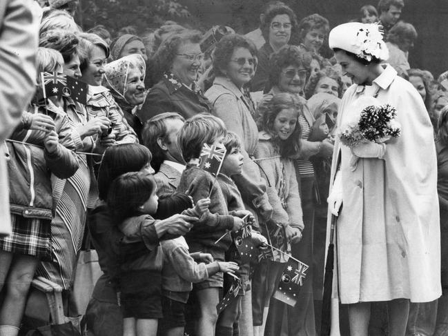 Queen Elizabeth II stops to talk to a group of children on her Rundle Mall walk.