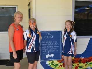 STAND TOGETHER: Principal Susan Wright and school captains Xanthea Kugel and Felicity Boon with the anti-bullying pledge. Picture: Dominic Elsome