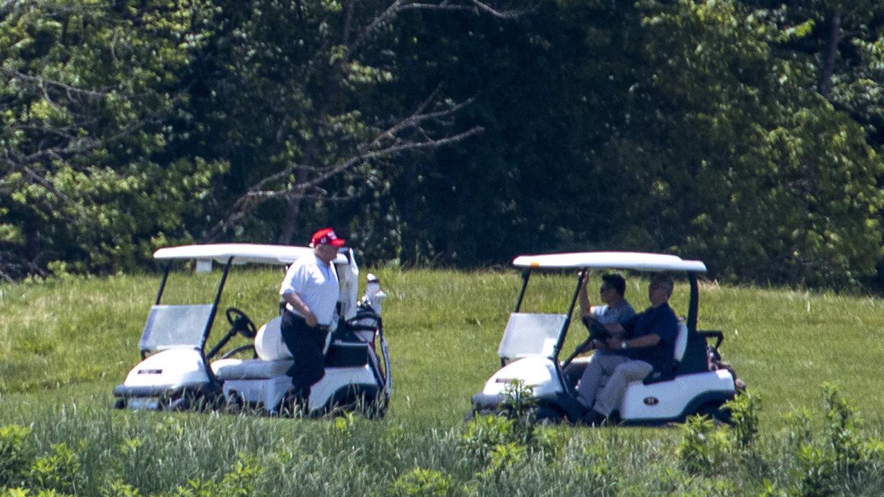 Donald Trump tees off in the midst of the coronavirus pandemic. Picture: AFP
