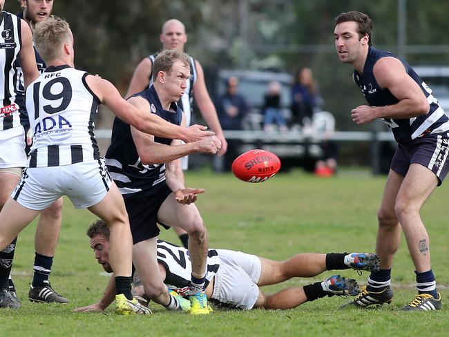 Matthew Fry, pictured handball during a 2016 game, celebrated his 200th game for Noarlunga on Saturday. Picture: Stephen Laffer