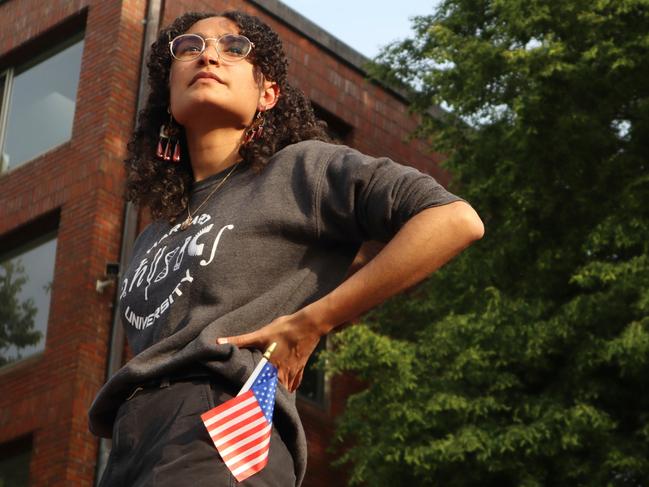 Harvard University junior Avinashi Bhandari stands on the podium before speaking at the protest in front of Harvard’s Science Center Plaza. Picture: AP
