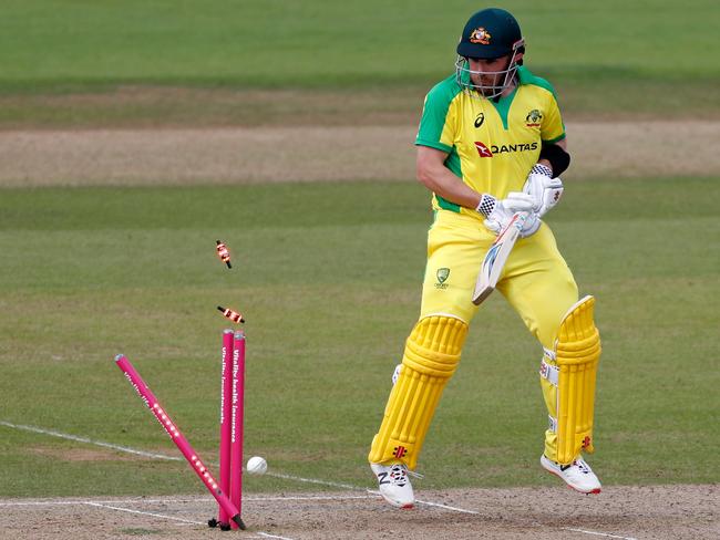 Aaron Finch looks back on his stumps after being bowled. Picture: AFP Photo