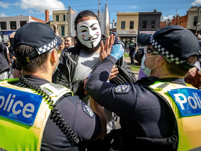 MELBOURNE, AUSTRALIA - SEPTEMBER 13: Protesters clash with Police at the Queen Victoria Market on September 13, 2020 in Melbourne, Australia. Anti-lockdown protesters organised a "freedom walk" to demonstrate against Melbourne's current Stage 4 COVID-19 restrictions. While organisers claim the gathering is legal, Victoria Police said they would be monitoring protest activity, with anyone considered to be breaching the Chief Health Officer's directives liable for a fine of $1652. Metropolitan Melbourne remains under stage 4 lockdown restrictions, with people only allowed to leave home to give or receive care, shopping for food and essential items, daily exercise and work while an overnight curfew from 8pm to 5am is also in place. The majority of retail businesses are also closed. Other Victorian regions are in stage 3 lockdown. The restrictions, which came into effect from 2 August, were introduced by the Victorian government as health authorities work to reduce community COVID-19 transmissions across the state. (Photo by Darrian Traynor/Getty Images)