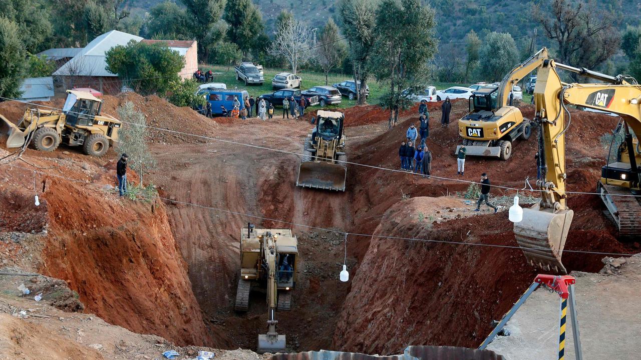 Moroccan authorities and firefighters work to get five-year-old child Rayan out of a well into which he fell after 48 hours earlier, on February 3, 2022 in the region of Chefchaouen near the city of Bab Berred. (Photo by AFP)