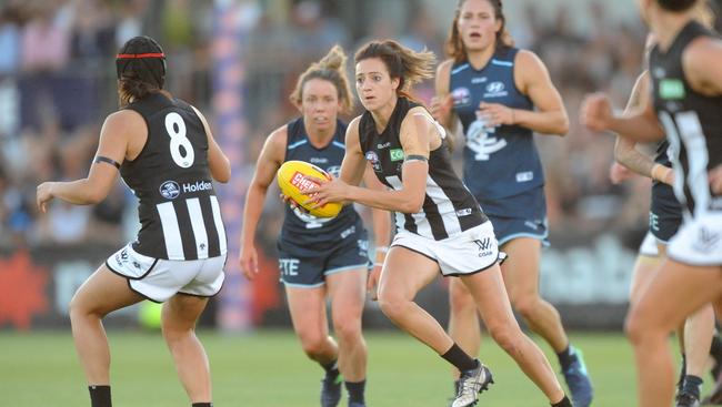 Stephanie Chiocci of Collingwood (centre) runs with the ball during last year’s round 1 AFLW match between the Carlton Blues and the Collingwood Magpies at Ikon Park in Melbourne. Photo: AAP Image/Joe Castro