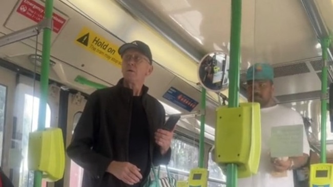 Another passenger (right, wearing a white shirt) compliments the woman’s shirt, before the complaining man is seen exiting the tram. Picture: Supplied / TikTok