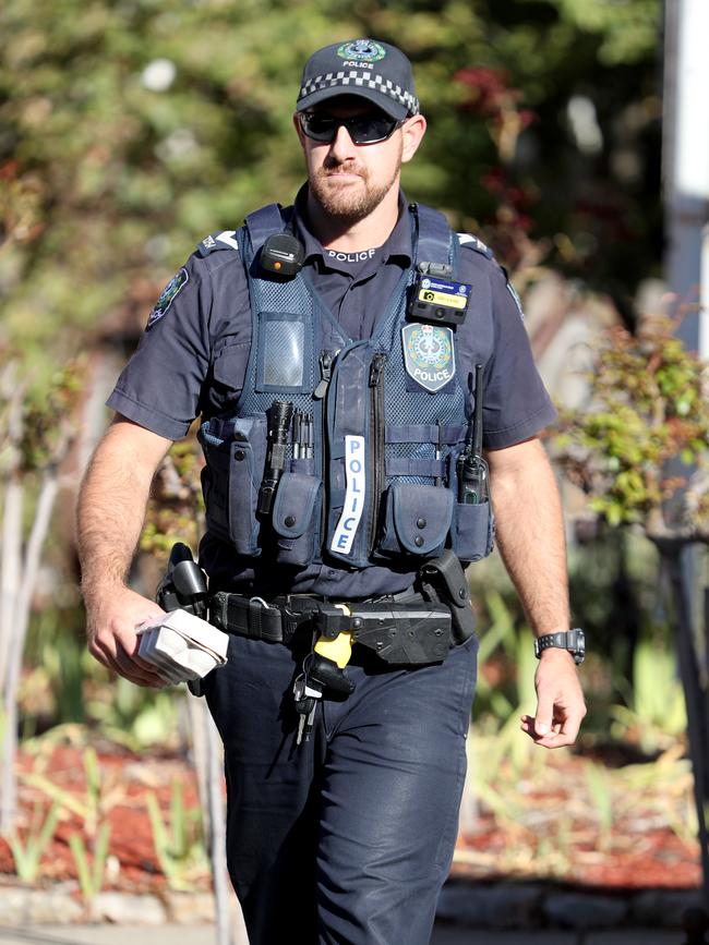 A police officer carries a carton of eggs that were confiscated from students protesting against controversial far-right Seantor Fraser Anning at Hahndorf on Thursday afternoon. Picture: AAP Image/Kelly Barnes