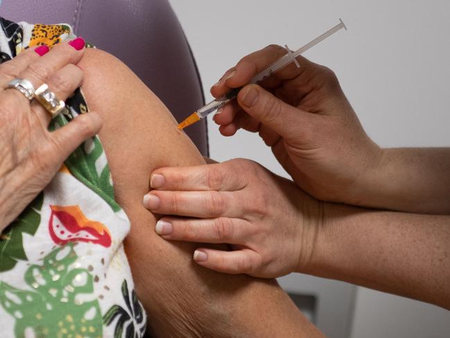 A pharmacist administers a dose of the AstraZeneca/Oxford vaccine to a woman in a pharmacy, in Savenay, western France. Picture: AFP