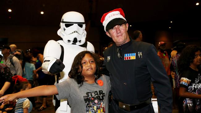 Curtis Lafragua, 9, from Mossman meets Star Wars characters stormtrooper (David Star) and Imperial Commander (Anthony Horsford) at the annual Special Children's Christmas Party held at the Cairns Convention Centre. PICTURE: STEWART MCLEAN