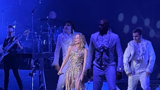 Kylie Minogue singing and dancing on stage with her crew. Picture: News Corp Australia