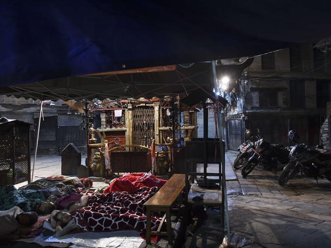 On the streets ... residents of one of Kathamandu's oldest quarters sleep out in the open. Picture: AFP/Roberto Schmidt