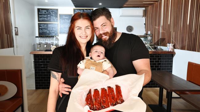 Gold Coast couple Amy and Marcus Nicholson with their young son Tommy after his bout with sepsis. Picture Glenn Hampson