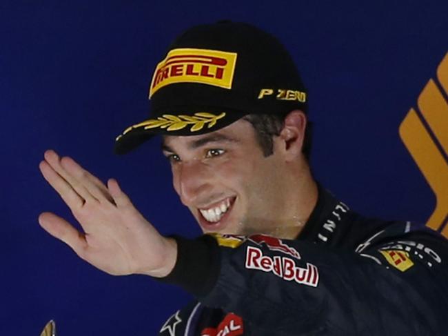 Red Bull Racing driver Daniel Ricciardo of Australia celebrates after finishing in third place at the Singapore Formula One Grand Prix on the Marina Bay City Circuit in Singapore, Sunday, Sept. 21, 2014. (AP Photo/Ng Han Guan)