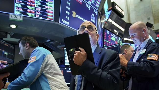 Traders watch US stocks sink after the Trump trade tweet. Picture: AFP