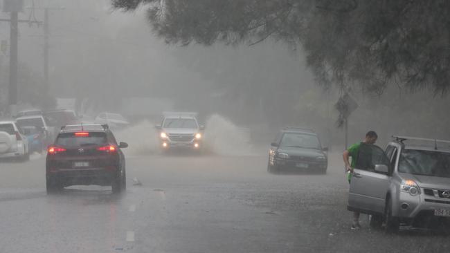 Major flooding in Millers rd at Currumbin. Media run to move their cars to avoid being part of the story. Picture: Glenn Hampson.