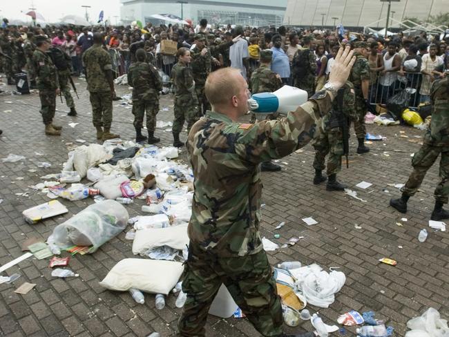 A Louisiana Army National Guard officer pleads for evacuees to stop from pushing forward during relief efforts at the Superdome in New Orleans, after the 2005 Hurricane Katrina disaster. The impact of an EMP attack would be far worse. Picture: AP