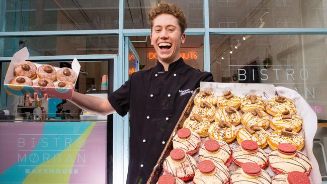 Morgan Hipworth at his now-iconic Melbourne bakehouse Bistro Morgan in Windsor with Doughnuts including the Creme Brulee and the Cookie Monster. Picture: Jason Edwards