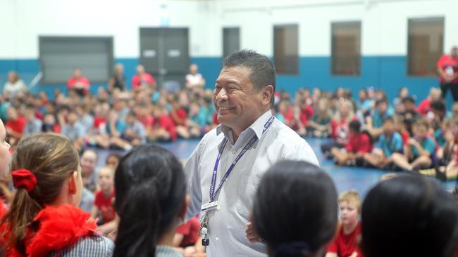 Hank Lewerissa with students at Upper Coomera State College at an assembly where he was honoured for 40 years as a teacher. Picture: Richard Gosling.