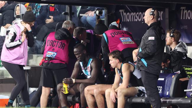 Aliir Aliir sits on the bench. Picture: Sarah Reed/AFL Photos via Getty