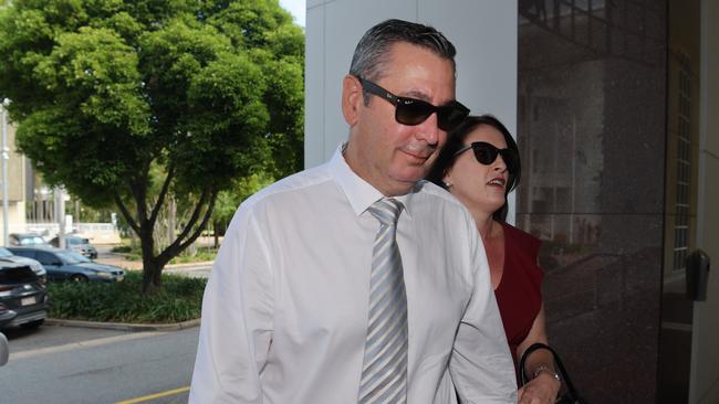 Former Elders real estate agent Chris Deutrom enters the NT Supreme Court with his wife, Helen