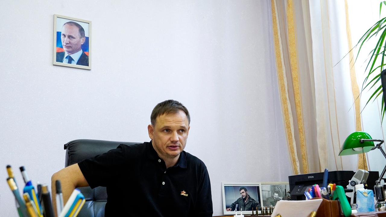 Kirill Stremousov, deputy head of the Russian-backed Kherson administration, is pictured in his office, with a portrait of Russian President Vladimir Putin seen on the wall behind him. (Photo by STRINGER / AFP)